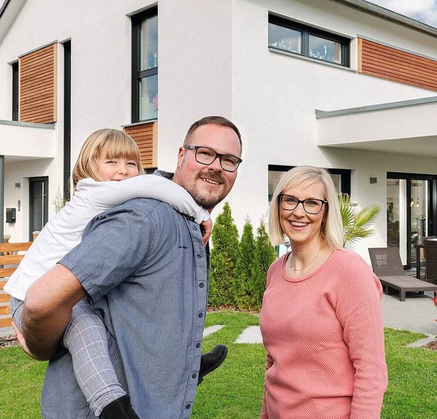 erikson family happy in front of their home
